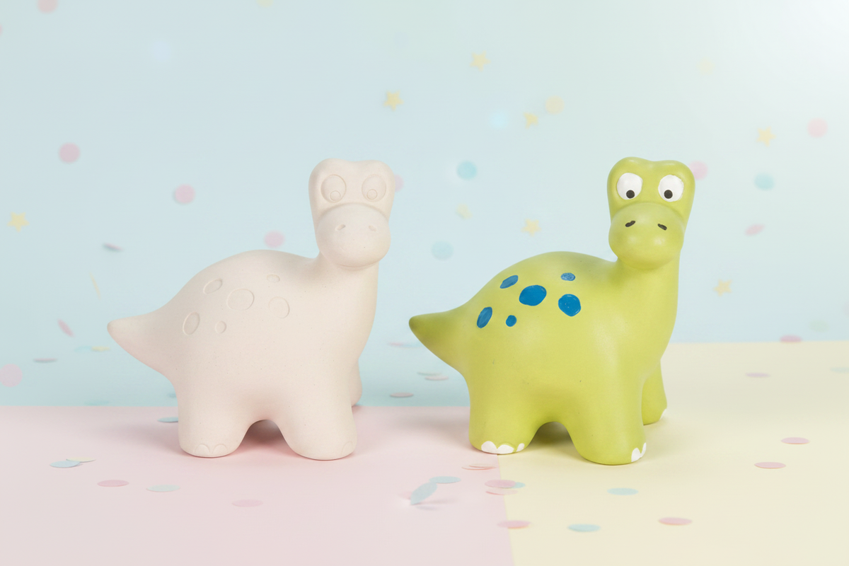Dinosaur coin banks with soft pastel playful background
